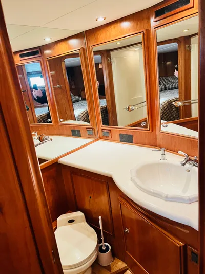 Journey Yacht Photos Pics Luxurious bathroom in 2001 Bracewell Latitude 47 yacht, featuring wood cabinetry and modern fixtures.