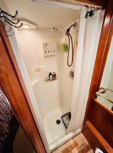 Journey Yacht Photos Pics Shower area in 2001 Bracewell Latitude 47 yacht, featuring wooden accents and modern fixtures.