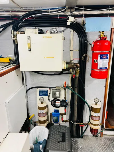 Journey Yacht Photos Pics Engine room of 2001 Bracewell Latitude 47 yacht with fire extinguisher and mechanical components.