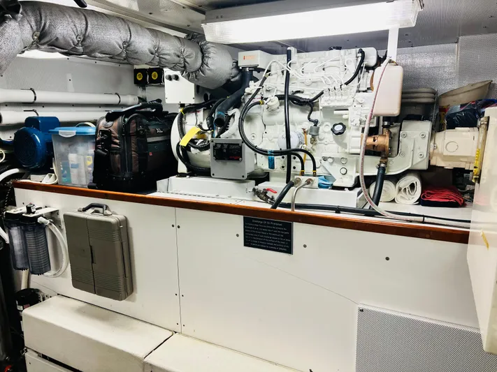 Journey Yacht Photos Pics Engine room of 2001 Bracewell Latitude 47 yacht, featuring complex machinery and storage solutions.