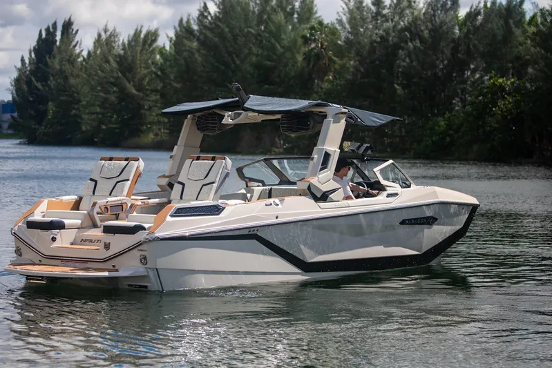  Yacht Photos Pics 2025 Nautique Super Air Nautique G25 Paragon on a serene lake.