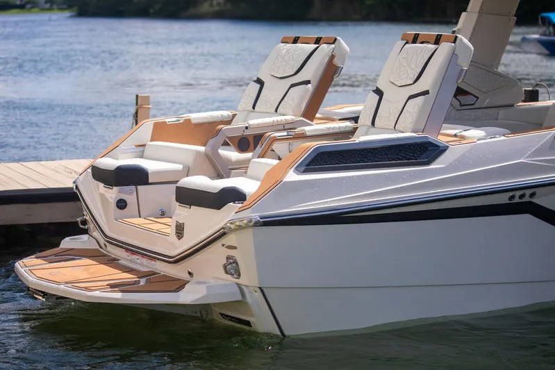  Yacht Photos Pics 2025 Nautique Super Air Nautique G25 Paragon luxury boat with elegant seating on the water.