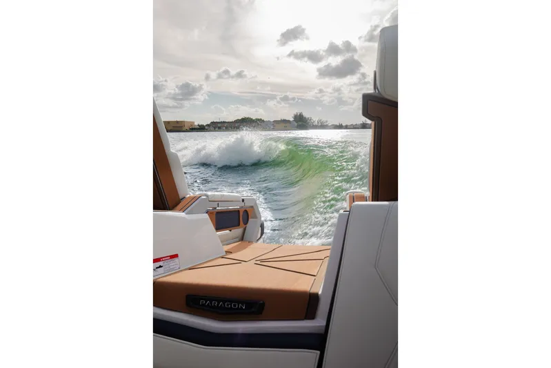  Yacht Photos Pics 2025 Nautique Super Air Nautique G25 Paragon creating waves on a sunny day.