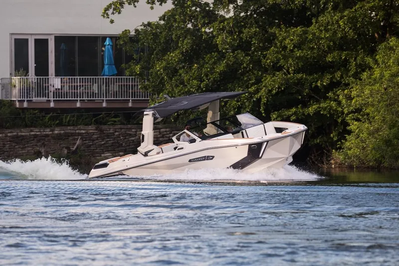  Yacht Photos Pics 2025 Nautique Super Air Nautique G25 Paragon cruising on a scenic waterway.