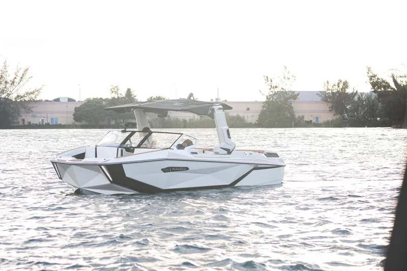 Yacht Photos Pics 2025 Nautique Super Air Nautique G25 Paragon on water, sleek design, sunny day.