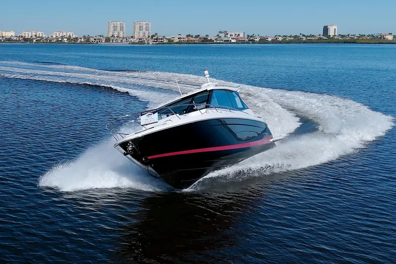 Elena Trinidad Yacht Photos Pics 2021 Regal 36 XO boat cruising swiftly on open water.