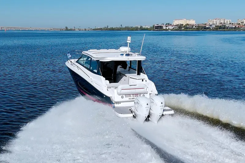 Elena Trinidad Yacht Photos Pics 2021 Regal 36 XO boat cruising on a calm lake with twin engines.
