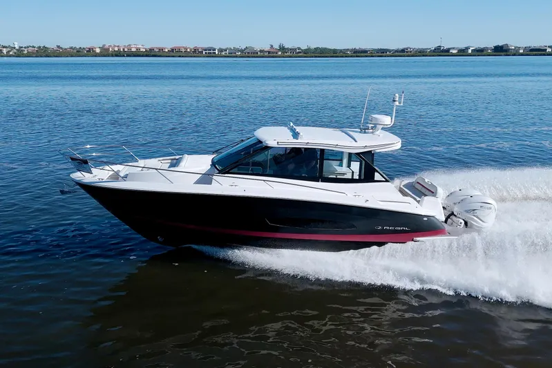 Elena Trinidad Yacht Photos Pics 2021 Regal 36 XO boat cruising on a calm blue lake.