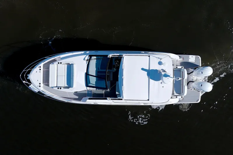 Elena Trinidad Yacht Photos Pics Aerial view of 2021 Regal 36 XO boat cruising on dark water.