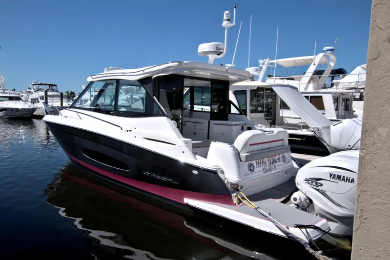 Elena Trinidad Yacht Photos Pics 2021 Regal 36 XO boat docked, featuring sleek design and Yamaha outboard engines.