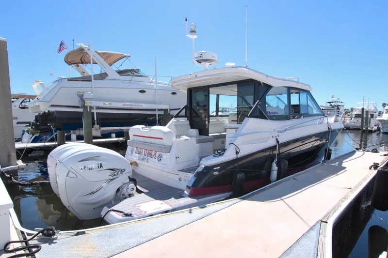 Elena Trinidad Yacht Photos Pics 2021 Regal 36 XO boat docked at marina, featuring sleek design and powerful outboard engines.