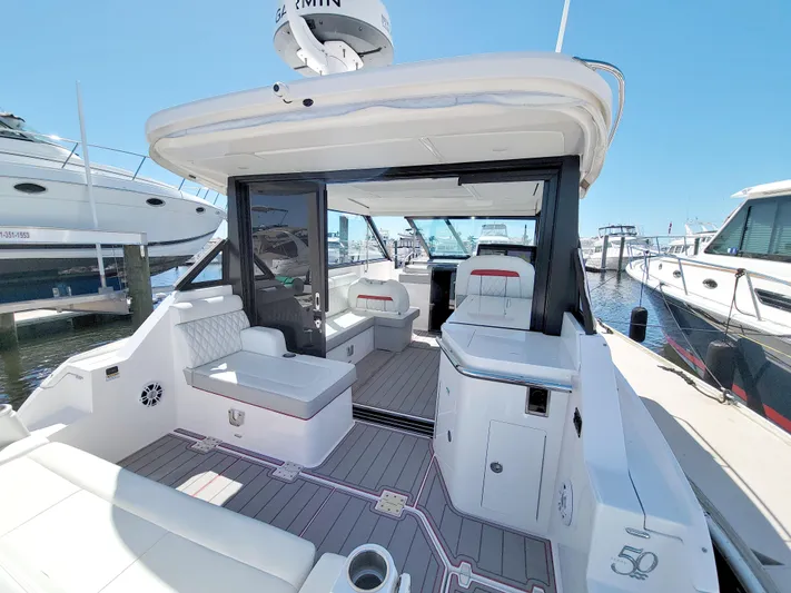 Elena Trinidad Yacht Photos Pics 2021 Regal 36 XO yacht interior with modern seating and sleek design at a marina.