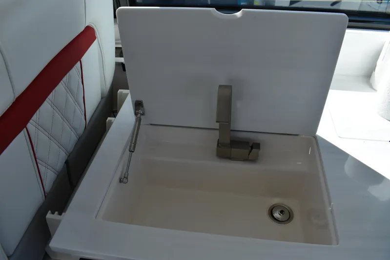 Elena Trinidad Yacht Photos Pics 2021 Regal 36 XO yacht sink with modern faucet and white cover.