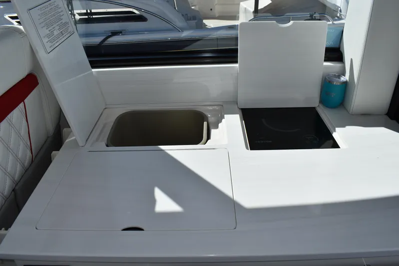 Elena Trinidad Yacht Photos Pics 2021 Regal 36 XO yacht kitchenette with sink and stove, featuring sleek white design.