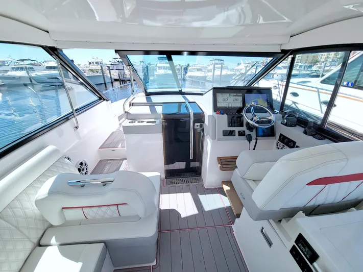 Elena Trinidad Yacht Photos Pics 2021 Regal 36 XO yacht interior with modern helm, plush seating, and marina view.