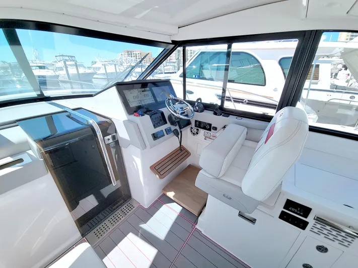 Elena Trinidad Yacht Photos Pics Helm of 2021 Regal 36 XO yacht with modern controls and white seating.