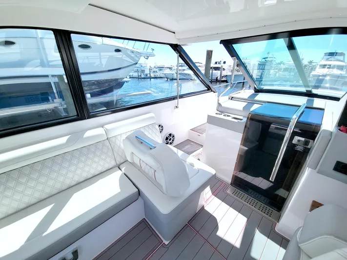 Elena Trinidad Yacht Photos Pics Interior of a 2021 Regal 36 XO yacht with luxurious seating and marina view.
