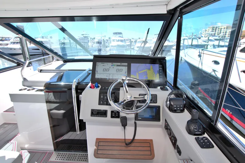 Elena Trinidad Yacht Photos Pics Helm of 2021 Regal 36 XO boat with modern navigation equipment and marina view.