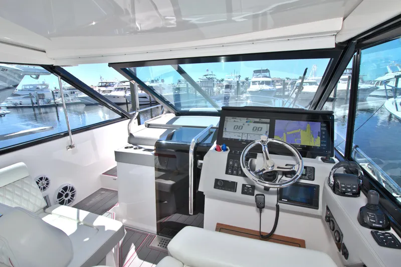 Elena Trinidad Yacht Photos Pics 2021 Regal 36 XO yacht cockpit with modern navigation system and marina view.