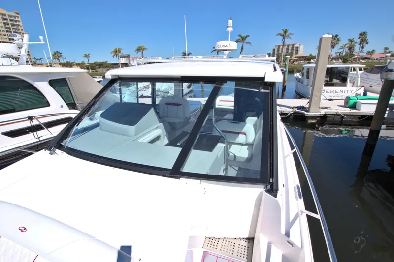 Elena Trinidad Yacht Photos Pics 2021 Regal 36 XO boat docked at marina, featuring sleek design and spacious interior.