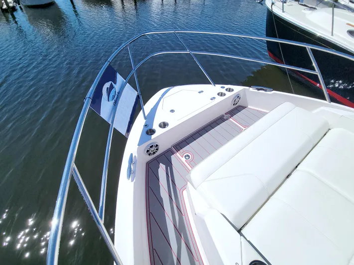 Elena Trinidad Yacht Photos Pics 2021 Regal 36 XO boat deck with seating, docked on calm water.