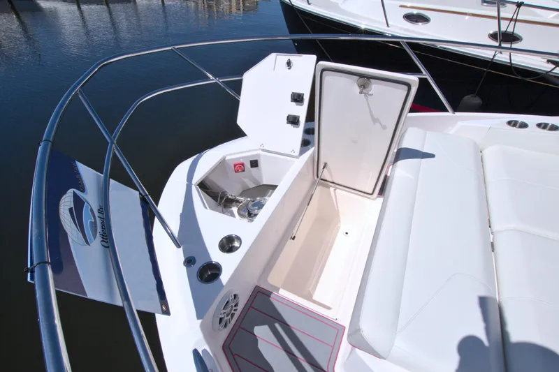 Elena Trinidad Yacht Photos Pics 2021 Regal 36 XO boat deck with open storage compartment and seating area.