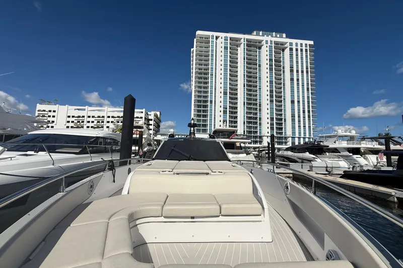 Chicken Money Yacht Photos Pics 2023 Azimut Verve 47 yacht docked at marina with modern high-rise buildings.