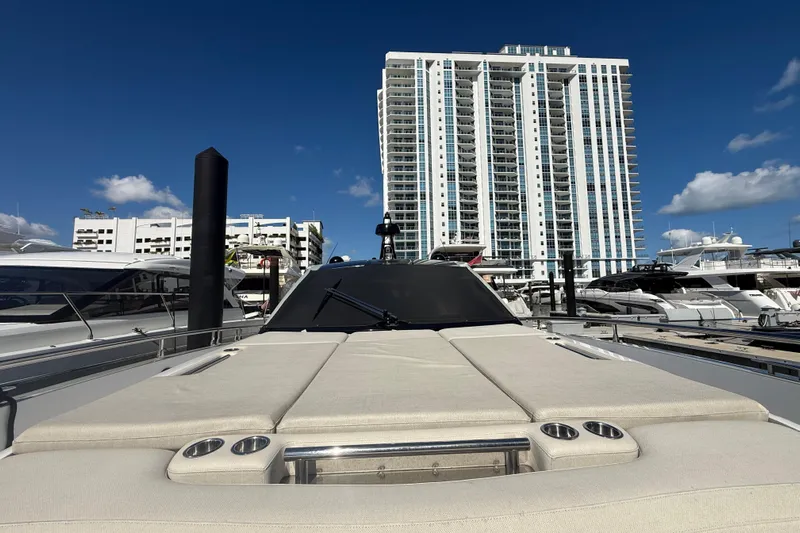 Chicken Money Yacht Photos Pics 2023 Azimut Verve 47 yacht docked with cityscape backdrop under clear blue sky.