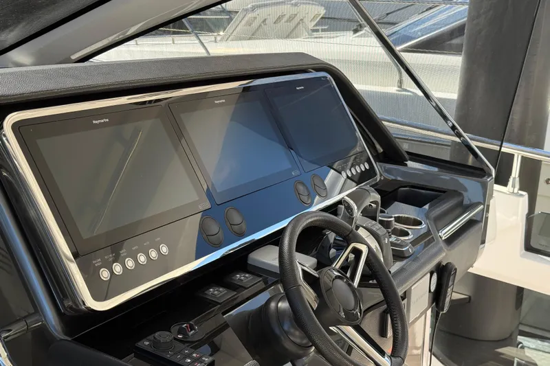 Chicken Money Yacht Photos Pics 2023 Azimut Verve 47 yacht helm with advanced navigation displays and controls.