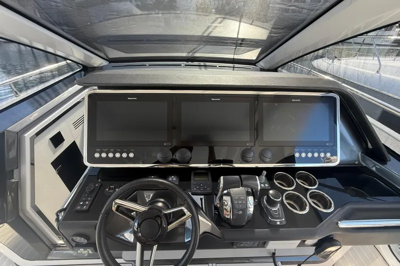 Chicken Money Yacht Photos Pics 2023 Azimut Verve 47 helm with advanced navigation displays and controls.