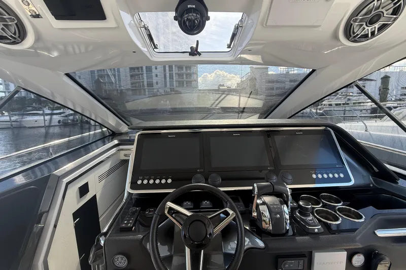 Chicken Money Yacht Photos Pics 2023 Azimut Verve 47 yacht cockpit with modern navigation screens and controls.