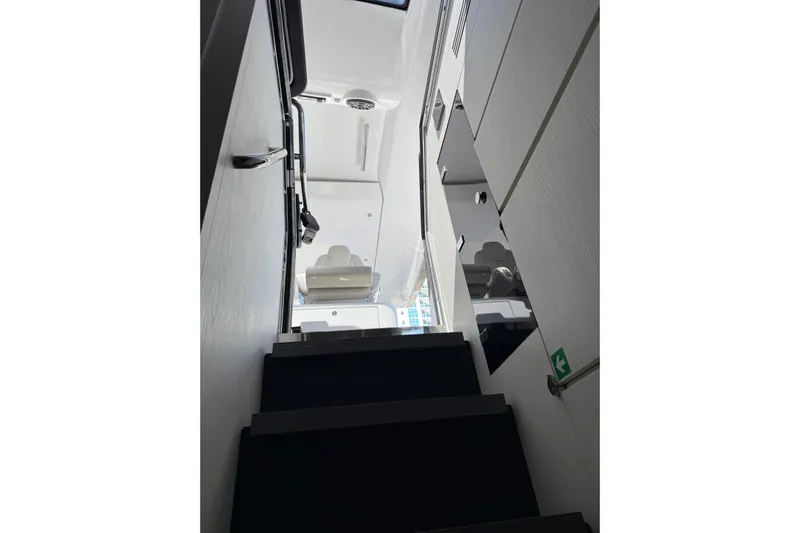 Chicken Money Yacht Photos Pics Interior staircase of 2023 Azimut Verve 47 yacht, featuring modern design and sleek finishes.