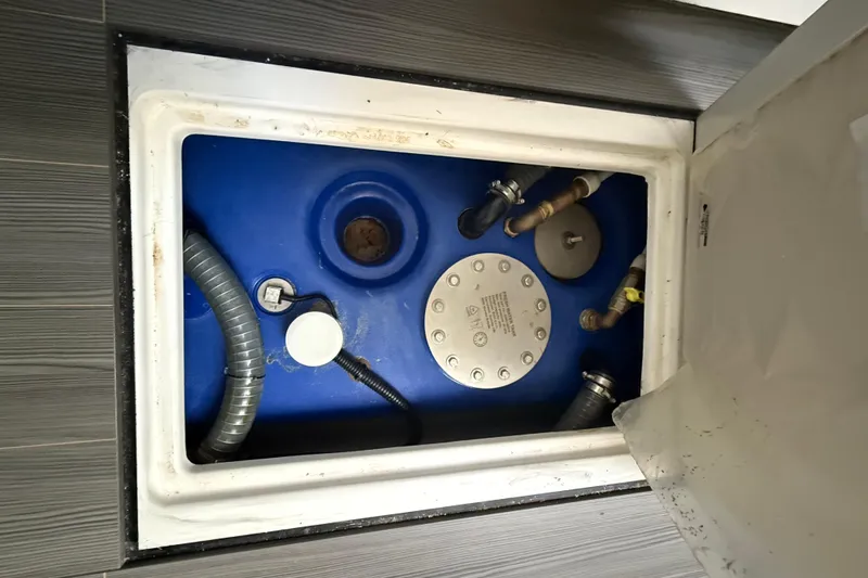 Chicken Money Yacht Photos Pics 2023 Azimut Verve 47 yacht's blue water tank with connected hoses and fittings.