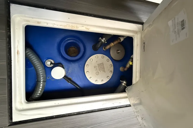 Chicken Money Yacht Photos Pics 2023 Azimut Verve 47 yacht's engine compartment with blue tank and hoses.