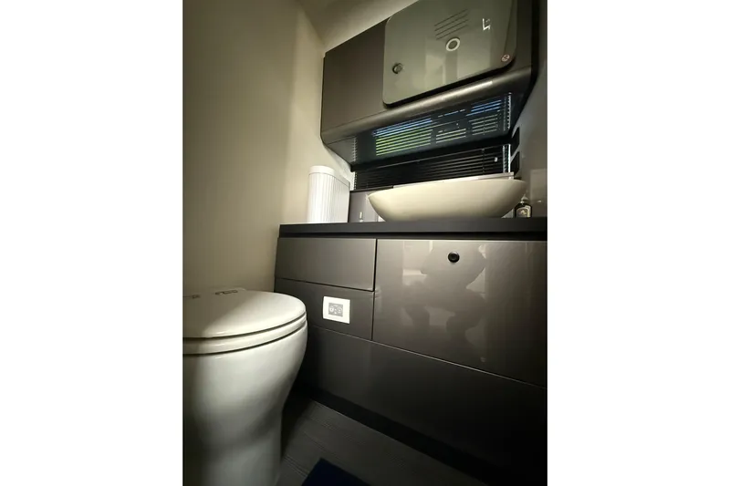 Chicken Money Yacht Photos Pics Modern bathroom interior in 2023 Azimut Verve 47 yacht, featuring sleek fixtures and elegant design.