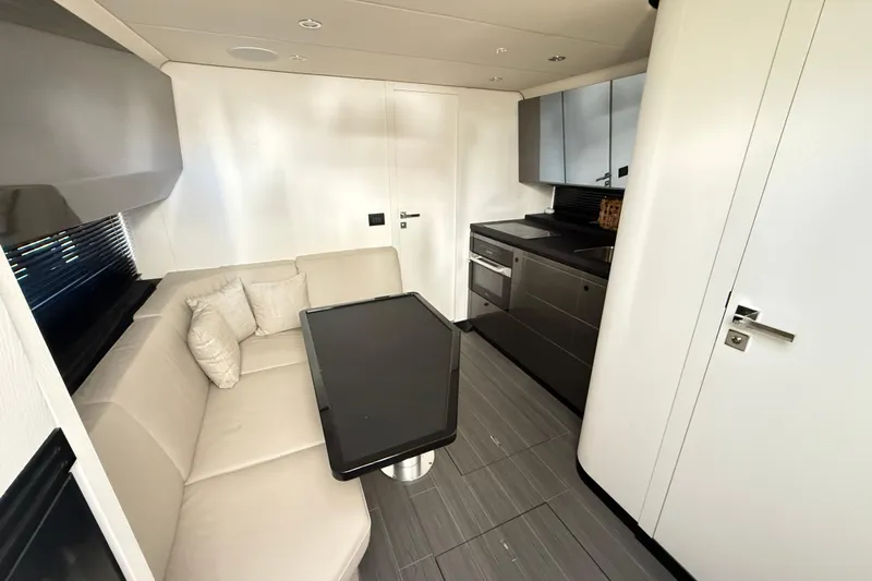 Chicken Money Yacht Photos Pics Luxurious interior of 2023 Azimut Verve 47 yacht with modern kitchen and seating area.