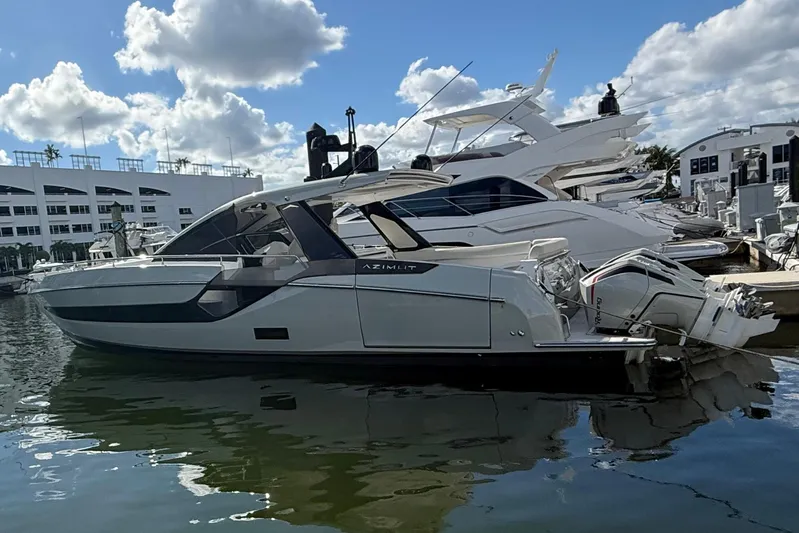 Chicken Money Yacht Photos Pics 2023 Azimut Verve 47 luxury yacht docked in marina under blue sky.