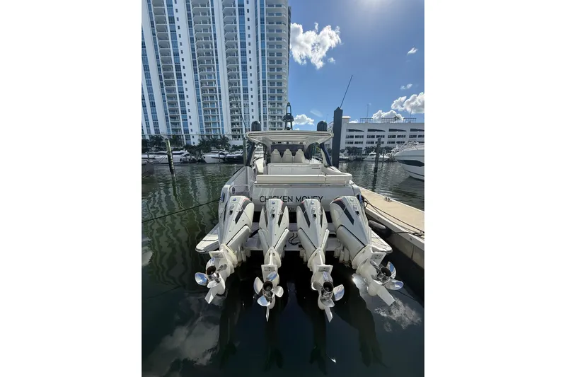 Chicken Money Yacht Photos Pics Azimut Verve 47 yacht docked, showcasing powerful outboard engines, 2023 model.