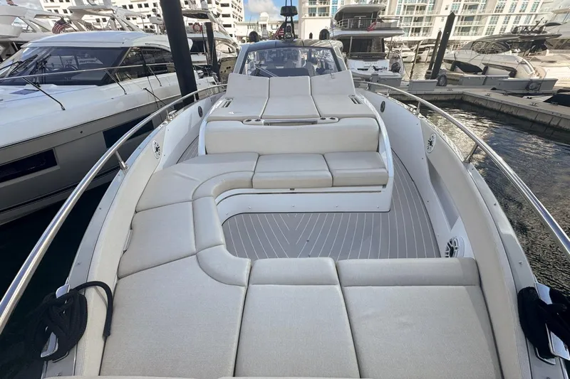 Chicken Money Yacht Photos Pics 2023 Azimut Verve 47 luxury yacht with spacious deck and elegant seating at marina.