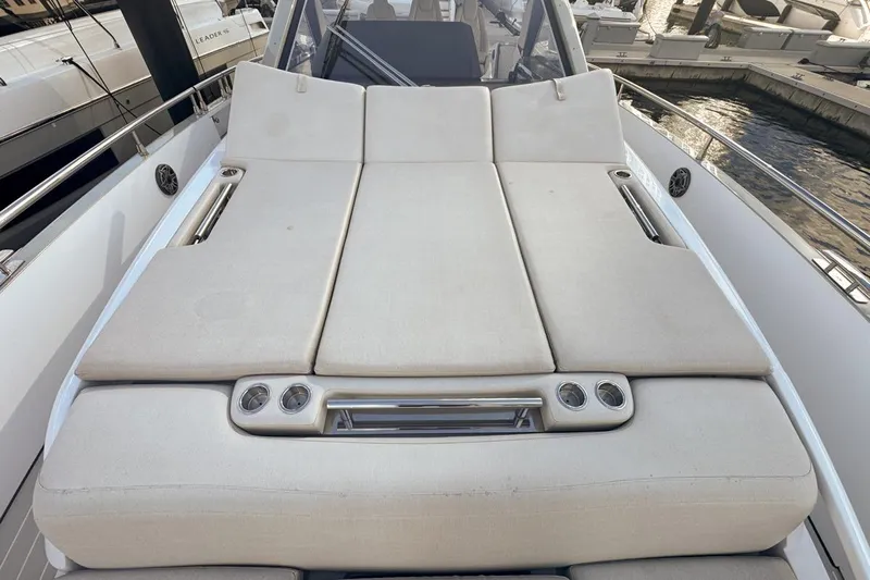 Chicken Money Yacht Photos Pics Luxurious sunbed on 2023 Azimut Verve 47 yacht, featuring comfortable cushions and cup holders.