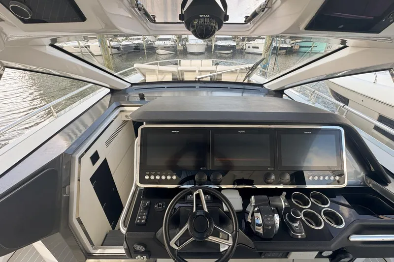 Chicken Money Yacht Photos Pics 2023 Azimut Verve 47 yacht cockpit with advanced navigation displays and controls.