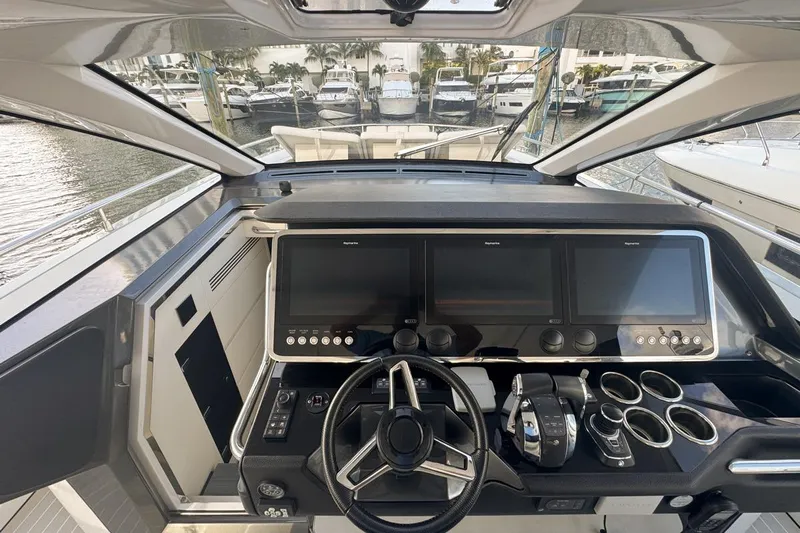 Chicken Money Yacht Photos Pics 2023 Azimut Verve 47 yacht cockpit with modern navigation screens and controls.