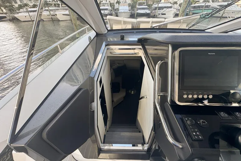 Chicken Money Yacht Photos Pics 2023 Azimut Verve 47 yacht interior with control panel and cabin entrance.