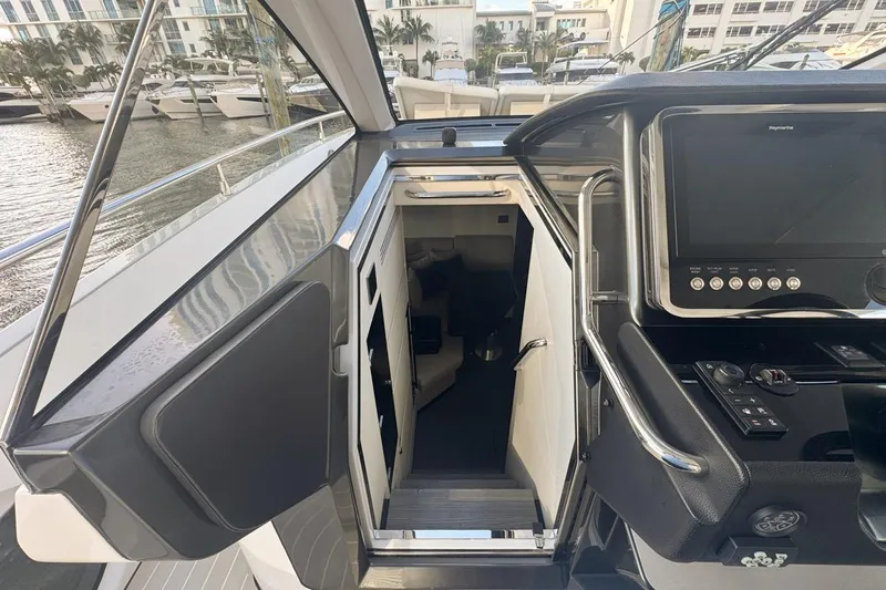 Chicken Money Yacht Photos Pics 2023 Azimut Verve 47 yacht interior entrance with control panel and marina view.