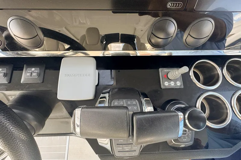 Chicken Money Yacht Photos Pics Control panel of 2023 Azimut Verve 47 yacht with steering and throttle controls.