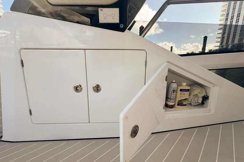 Chicken Money Yacht Photos Pics 2023 Azimut Verve 47 yacht storage compartment with cleaning supplies on deck.