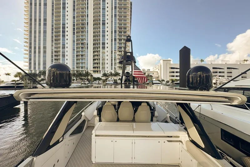 Chicken Money Yacht Photos Pics 2023 Azimut Verve 47 yacht docked near high-rise buildings, showcasing luxury design.