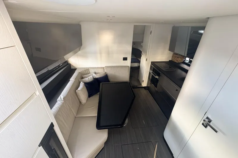 Chicken Money Yacht Photos Pics Luxurious interior of 2023 Azimut Verve 47 yacht with modern kitchen and seating area.