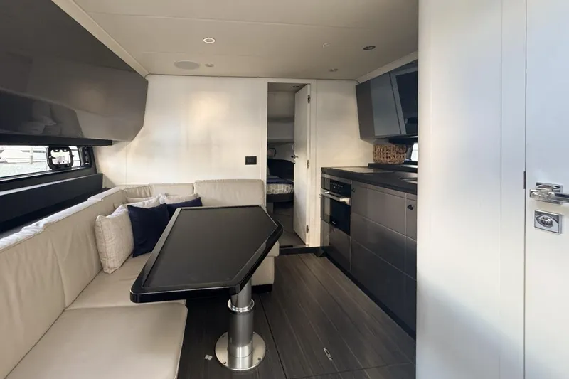 Chicken Money Yacht Photos Pics Luxurious interior of 2023 Azimut Verve 47 yacht with modern kitchen and seating area.
