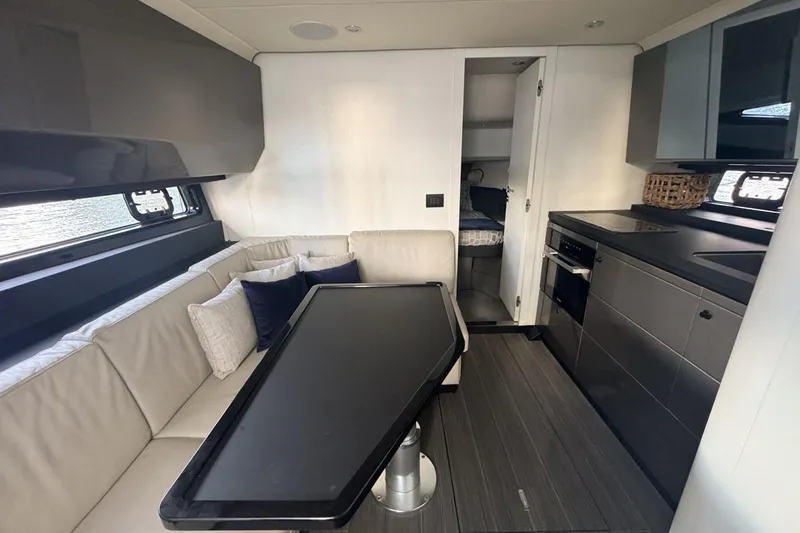 Chicken Money Yacht Photos Pics Luxurious interior of 2023 Azimut Verve 47 yacht with modern kitchen and seating area.